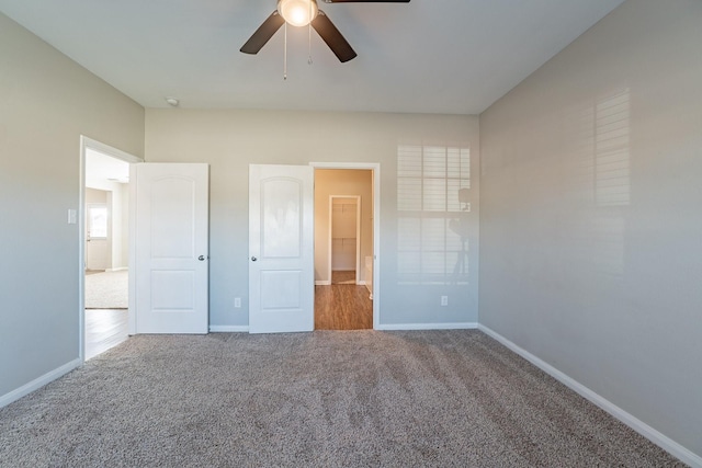 unfurnished bedroom featuring ceiling fan and carpet