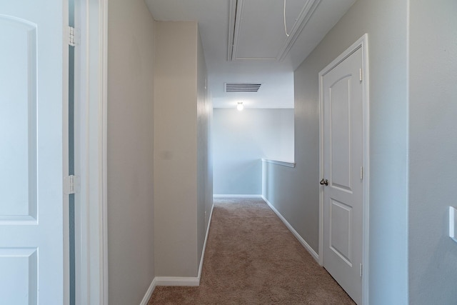 hall with light colored carpet