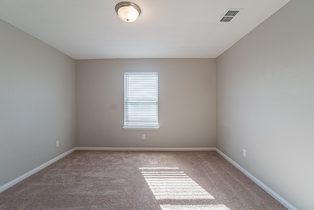 empty room featuring light colored carpet