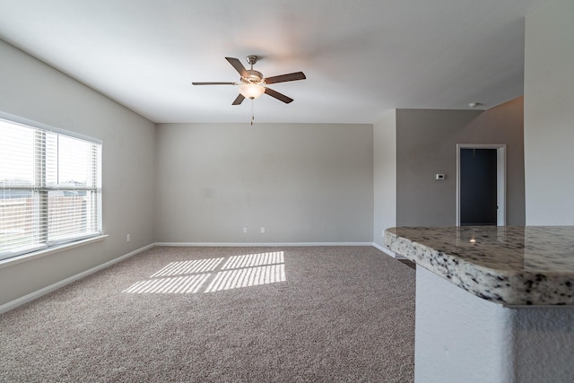 interior space with carpet flooring and ceiling fan