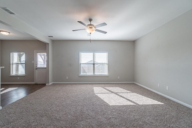 spare room with ceiling fan and dark hardwood / wood-style flooring