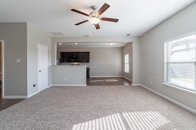 unfurnished living room with ceiling fan and dark hardwood / wood-style flooring