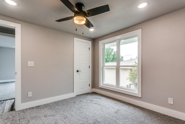 spare room featuring carpet and ceiling fan