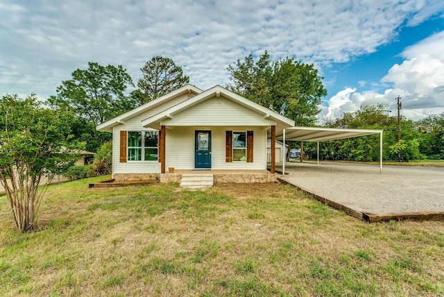 view of front facade with a carport, covered porch, and a front yard