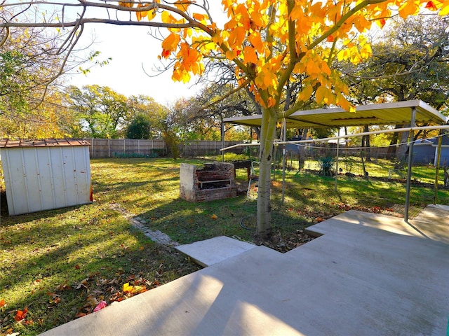 view of yard with a shed and a patio area