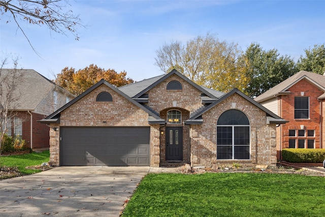 view of front of property featuring a garage and a front lawn