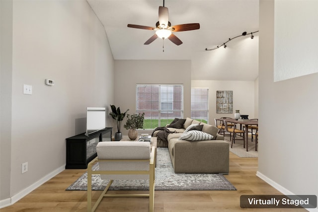 living room featuring light hardwood / wood-style flooring and ceiling fan