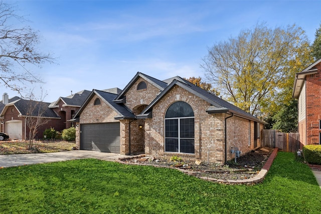 view of front of house with a front yard and a garage