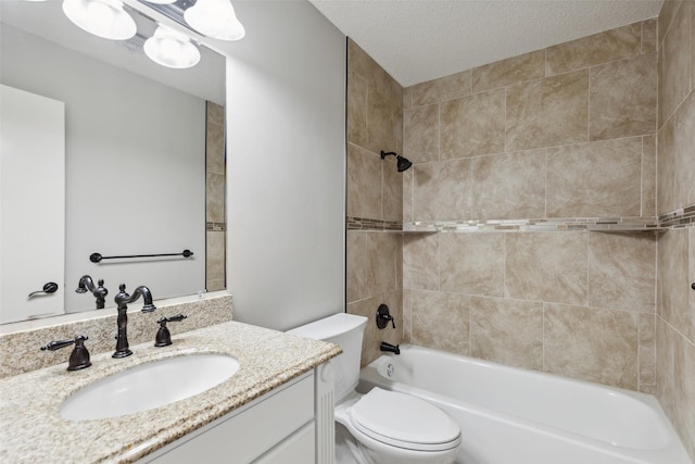 full bathroom featuring vanity, tiled shower / bath combo, a textured ceiling, and toilet