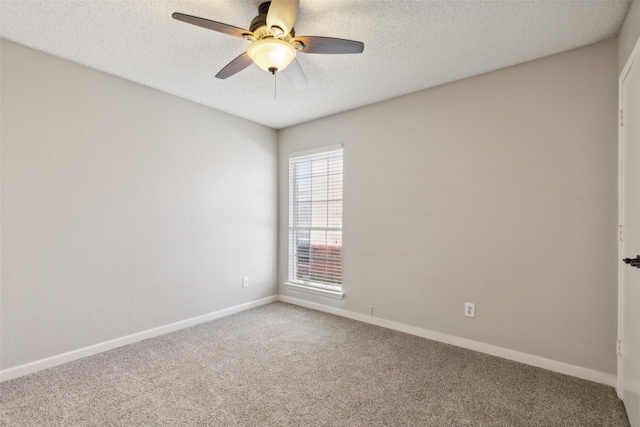 carpeted empty room featuring ceiling fan and a textured ceiling