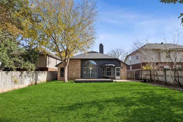 back of property with a patio and a lawn