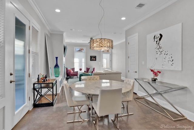 kitchen featuring sink, white cabinets, pendant lighting, a kitchen island, and appliances with stainless steel finishes