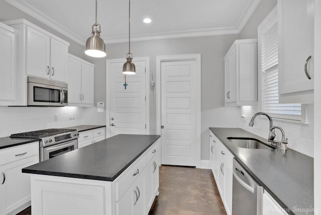 kitchen featuring white cabinets, a center island, stainless steel appliances, and hanging light fixtures