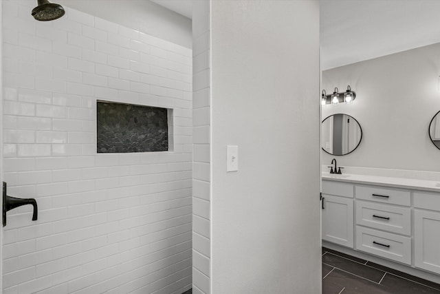 bathroom with vanity and a tile shower