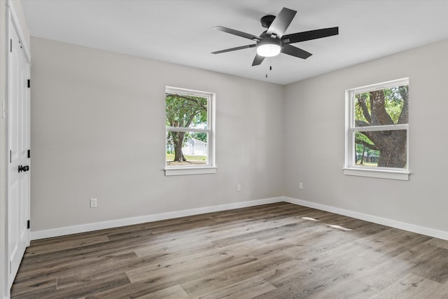 unfurnished room with dark hardwood / wood-style floors and ceiling fan