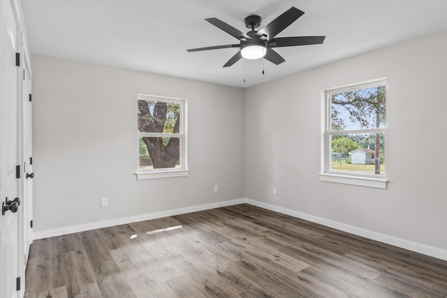 unfurnished room featuring dark hardwood / wood-style floors and ceiling fan