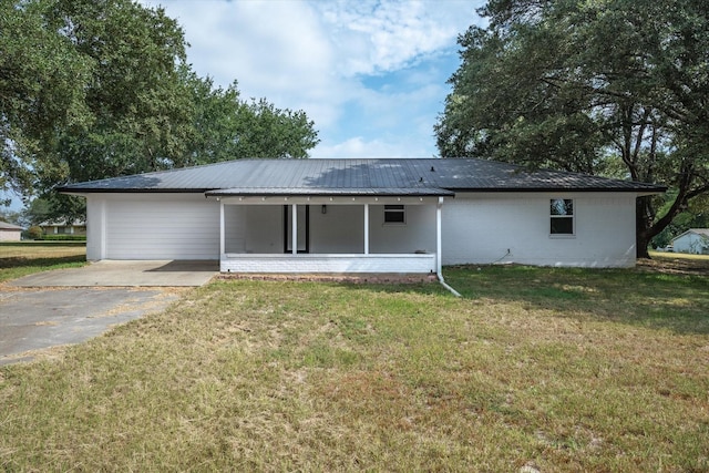 rear view of house featuring a yard