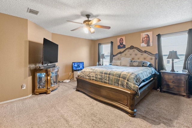 carpeted bedroom with multiple windows, visible vents, and a textured ceiling