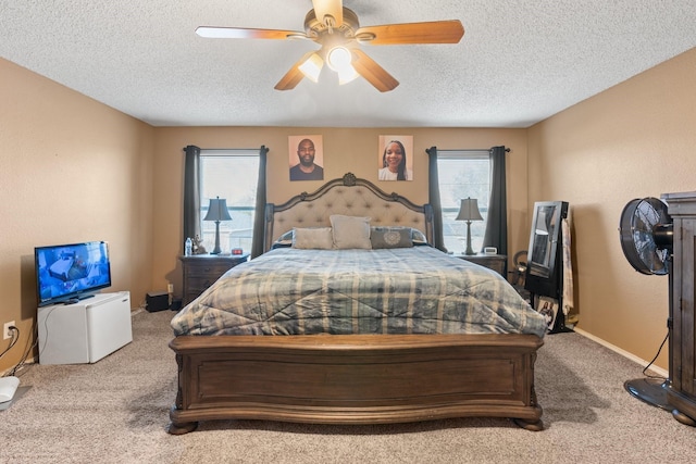 bedroom with carpet floors, multiple windows, baseboards, and a ceiling fan