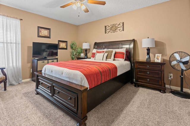 bedroom with a ceiling fan, light carpet, and baseboards