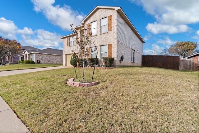 view of front of house with a garage and a front lawn