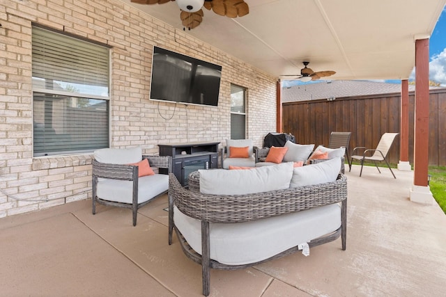 view of patio / terrace with ceiling fan, fence, and an outdoor hangout area