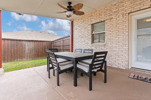 view of patio / terrace featuring outdoor dining space, a fenced backyard, and a ceiling fan