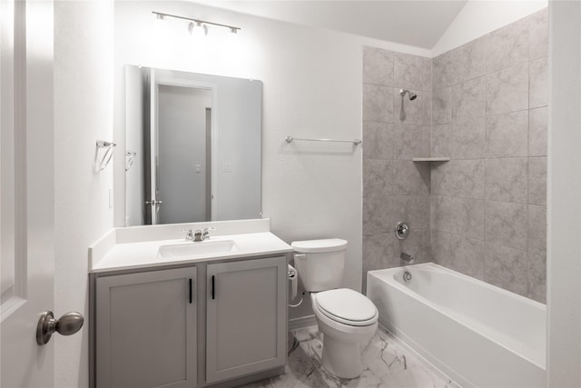 full bathroom featuring vanity, tiled shower / bath combo, toilet, and vaulted ceiling