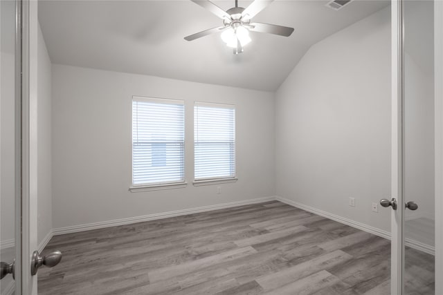 empty room featuring ceiling fan, light hardwood / wood-style floors, and lofted ceiling