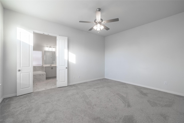 unfurnished bedroom featuring connected bathroom, ceiling fan, and light colored carpet