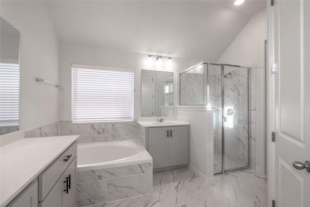 bathroom featuring vanity, lofted ceiling, and independent shower and bath