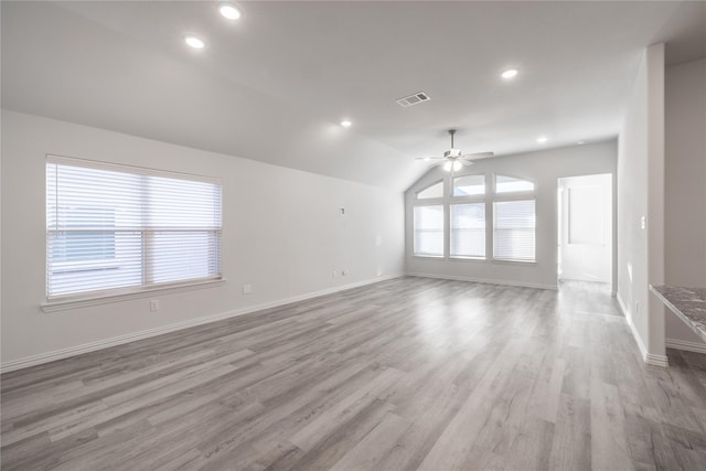 empty room featuring vaulted ceiling, light hardwood / wood-style floors, and ceiling fan