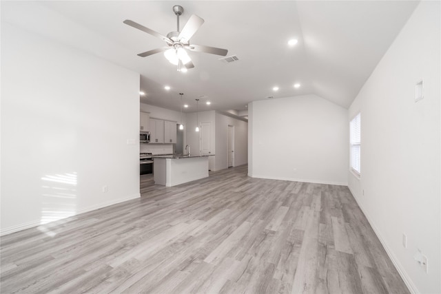 unfurnished living room with ceiling fan, light hardwood / wood-style floors, and lofted ceiling