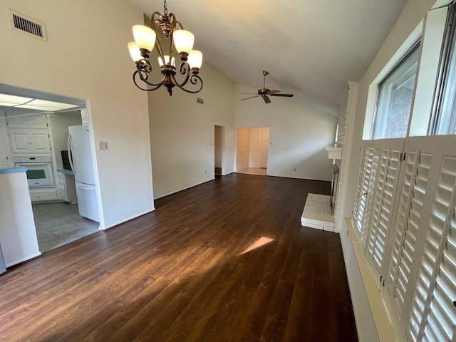 unfurnished living room with wood-type flooring, ceiling fan with notable chandelier, and high vaulted ceiling