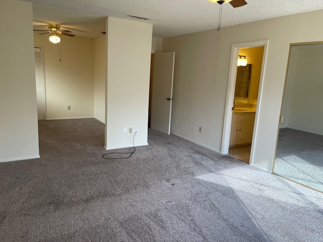 spare room featuring ceiling fan, carpet floors, and a textured ceiling