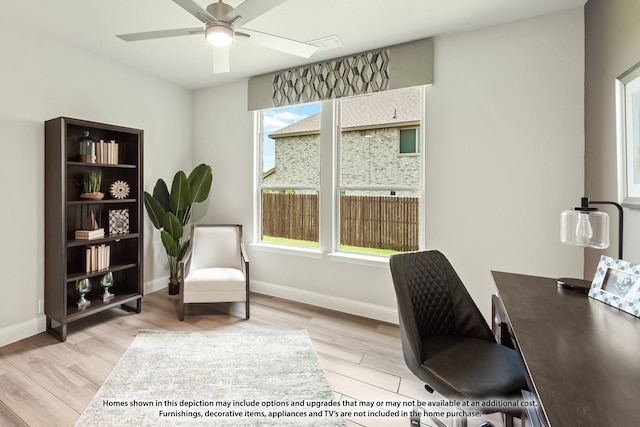 home office featuring light hardwood / wood-style flooring and ceiling fan