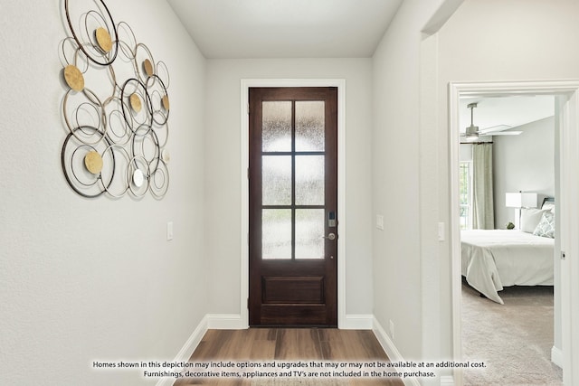 foyer with ceiling fan and wood-type flooring