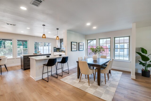 dining space featuring ceiling fan and light wood-type flooring