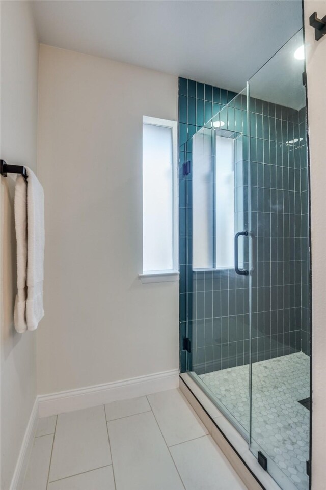 bathroom featuring a shower with shower door