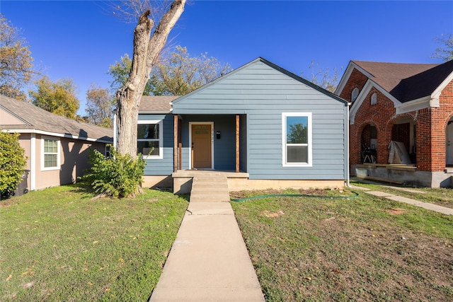 view of front of house with a front yard and covered porch