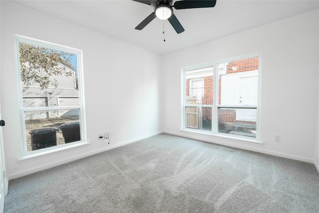 carpeted spare room with ceiling fan