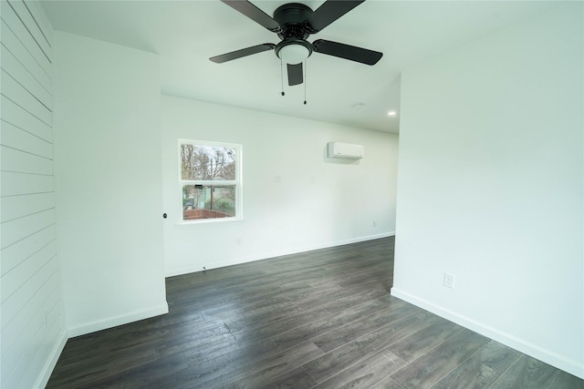 empty room featuring a wall mounted air conditioner, dark hardwood / wood-style floors, and ceiling fan