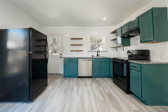 kitchen with black appliances, sink, light hardwood / wood-style flooring, tasteful backsplash, and light stone counters