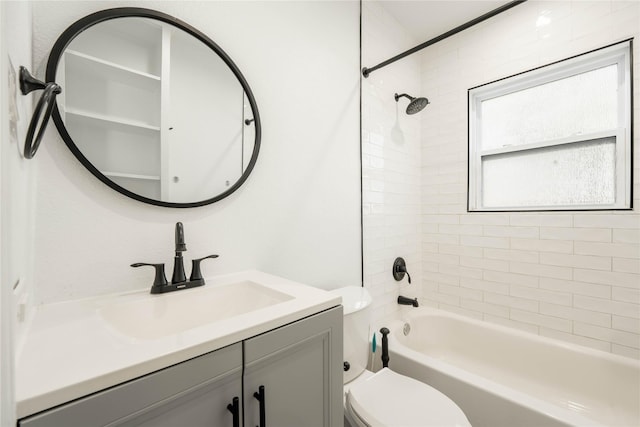 full bathroom with toilet, vanity, and tiled shower / bath