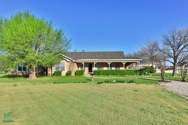 ranch-style home featuring a front yard