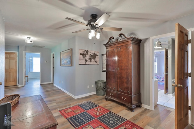 interior space featuring light hardwood / wood-style floors and ceiling fan