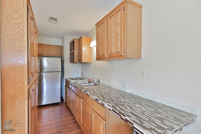 kitchen featuring stainless steel fridge, sink, dark wood-type flooring, and light brown cabinets