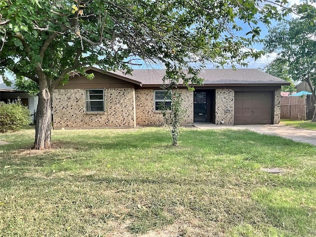 single story home featuring a garage and a front lawn