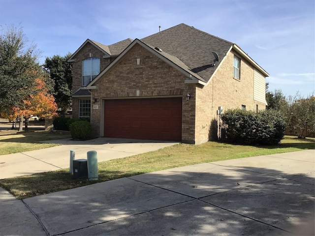 view of front of house featuring a garage and a front lawn