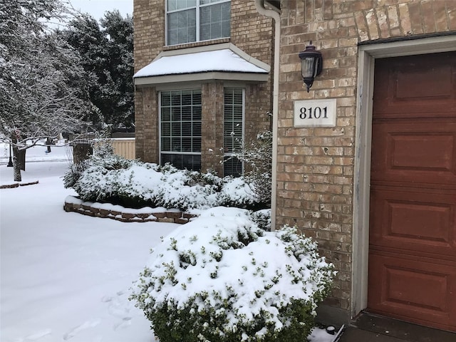 view of snow covered property entrance